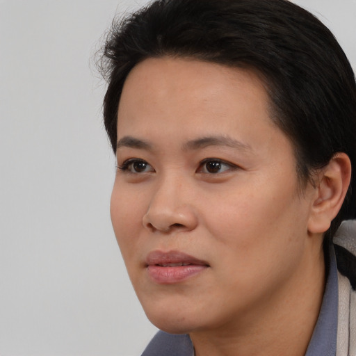 Joyful white young-adult female with short  black hair and brown eyes