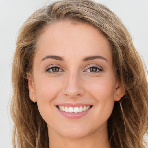 Joyful white young-adult female with long  brown hair and blue eyes