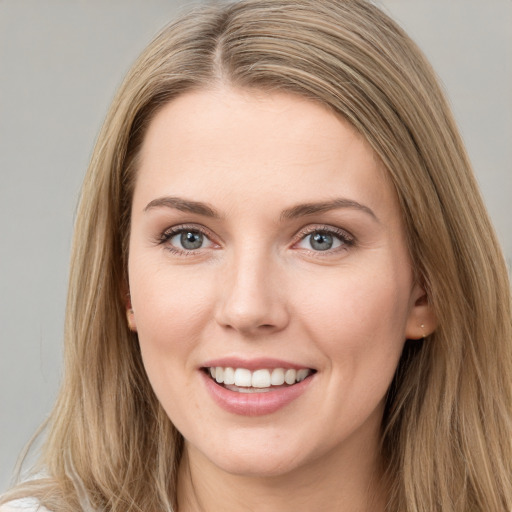 Joyful white young-adult female with long  brown hair and grey eyes