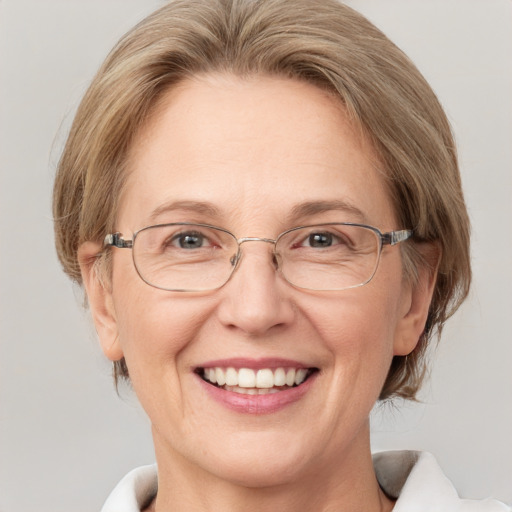 Joyful white middle-aged female with medium  brown hair and blue eyes