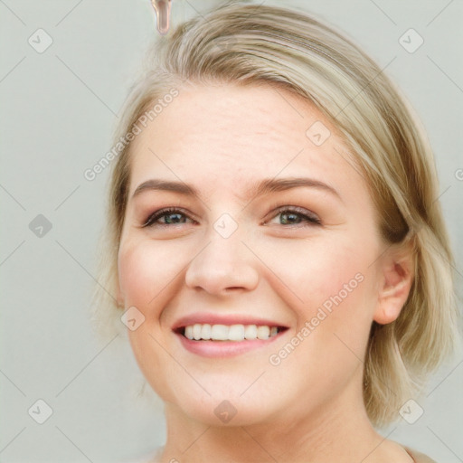 Joyful white young-adult female with long  brown hair and blue eyes