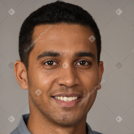 Joyful latino young-adult male with short  black hair and brown eyes