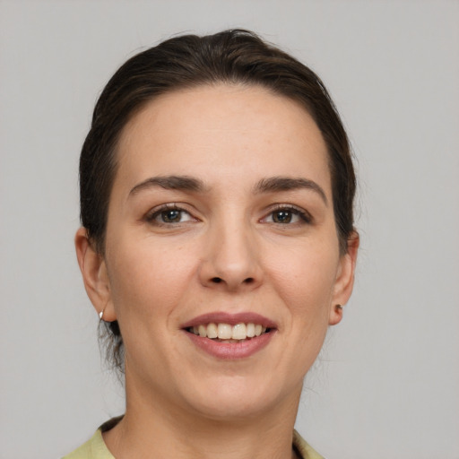 Joyful white young-adult female with medium  brown hair and brown eyes