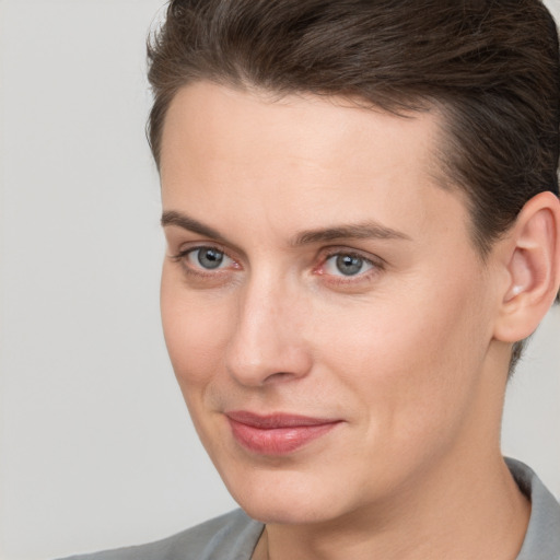 Joyful white young-adult female with short  brown hair and brown eyes