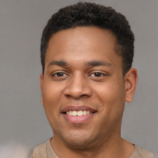 Joyful latino young-adult male with short  brown hair and brown eyes