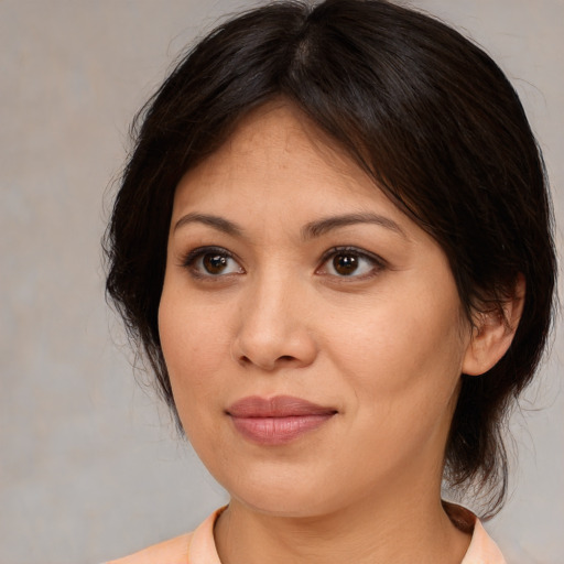 Joyful white adult female with medium  brown hair and brown eyes