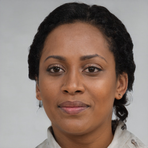 Joyful black young-adult female with medium  brown hair and brown eyes
