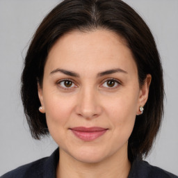 Joyful white adult female with medium  brown hair and brown eyes