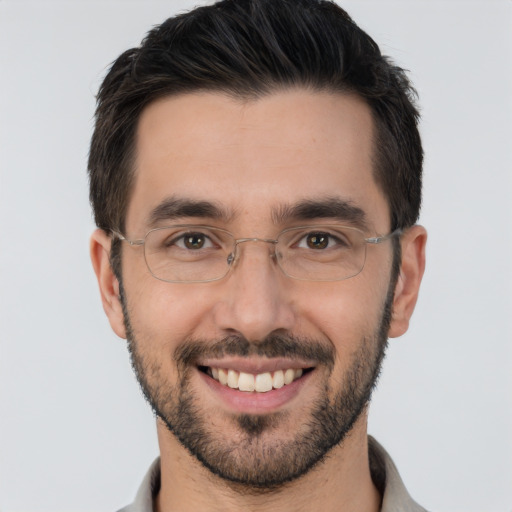 Joyful white young-adult male with short  black hair and brown eyes