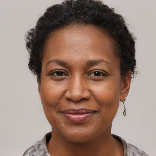 Joyful black adult female with short  brown hair and brown eyes