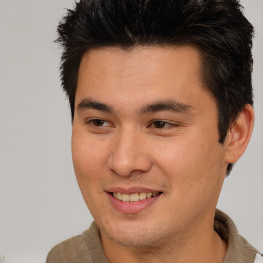 Joyful asian young-adult male with short  brown hair and brown eyes