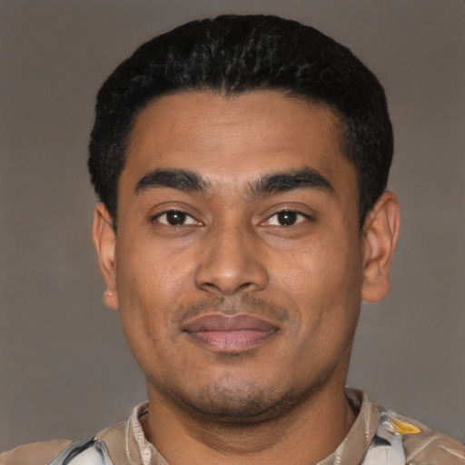 Joyful latino young-adult male with short  black hair and brown eyes