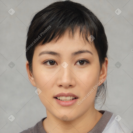 Joyful asian young-adult female with short  black hair and brown eyes