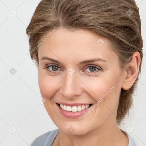 Joyful white young-adult female with medium  brown hair and grey eyes