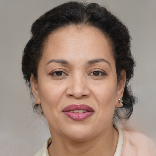 Joyful latino adult female with medium  brown hair and brown eyes