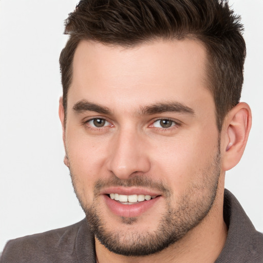 Joyful white young-adult male with short  brown hair and brown eyes