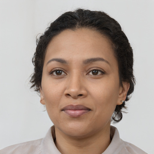 Joyful latino adult female with short  brown hair and brown eyes
