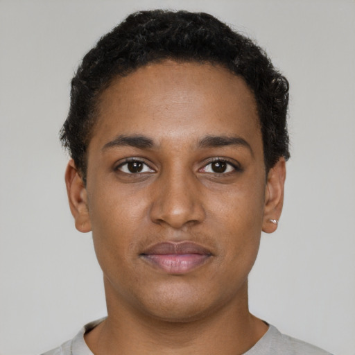 Joyful black young-adult male with short  brown hair and brown eyes