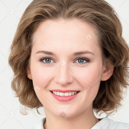 Joyful white young-adult female with medium  brown hair and blue eyes