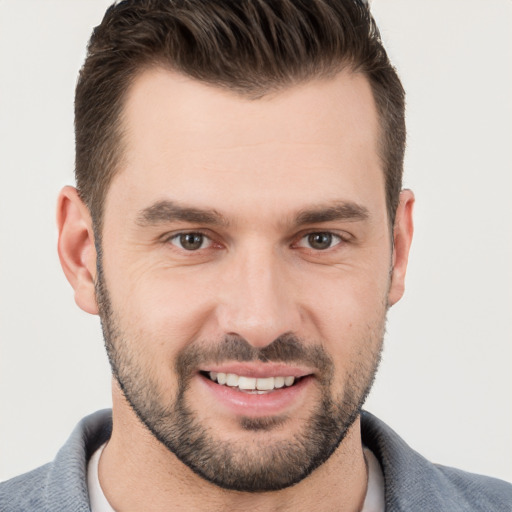 Joyful white young-adult male with short  brown hair and brown eyes