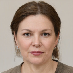 Joyful white adult female with medium  brown hair and grey eyes