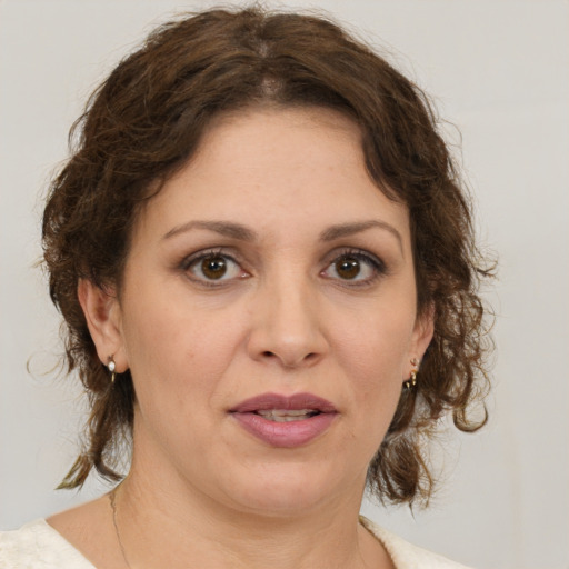 Joyful white adult female with medium  brown hair and brown eyes