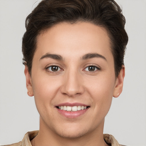 Joyful white young-adult female with short  brown hair and brown eyes