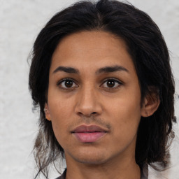 Joyful latino young-adult female with medium  brown hair and brown eyes