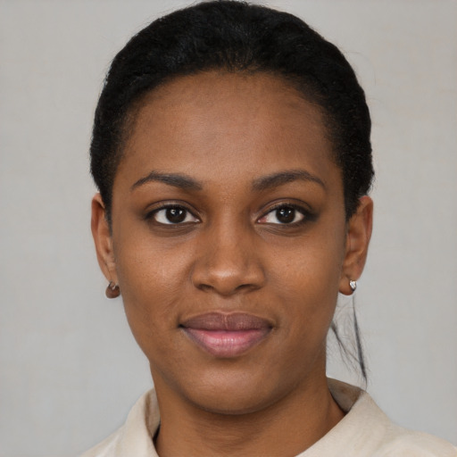 Joyful black young-adult female with short  black hair and brown eyes
