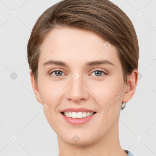 Joyful white young-adult female with short  brown hair and grey eyes