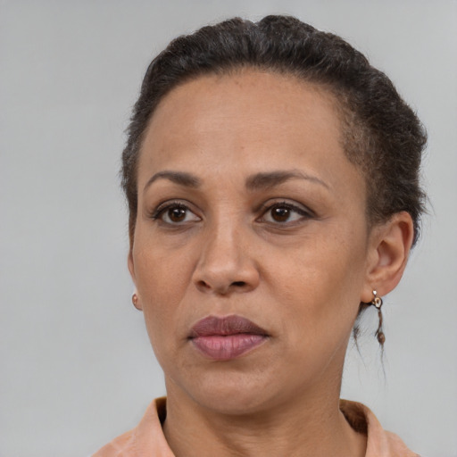 Neutral latino adult female with short  brown hair and brown eyes