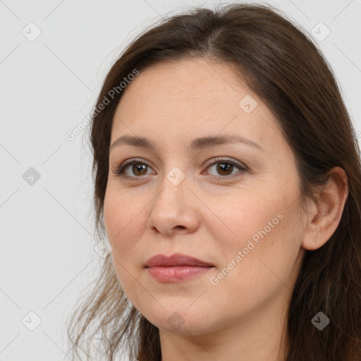 Joyful white adult female with long  brown hair and brown eyes