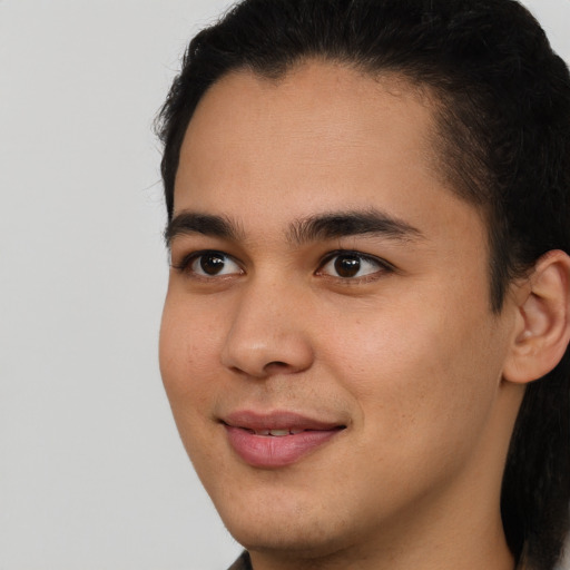 Joyful latino young-adult male with short  brown hair and brown eyes
