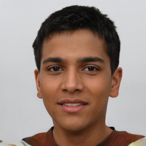 Joyful latino young-adult male with short  brown hair and brown eyes
