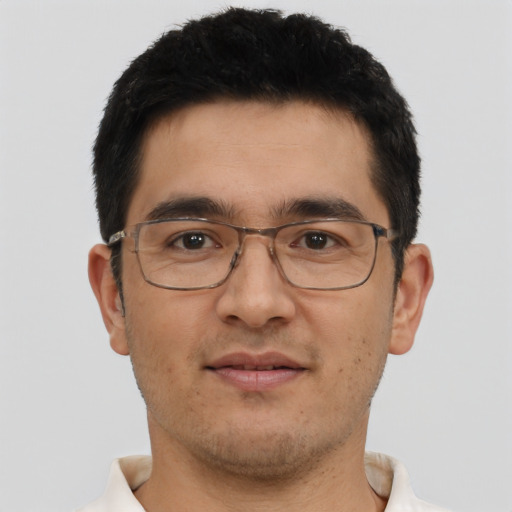 Joyful asian adult male with short  brown hair and brown eyes