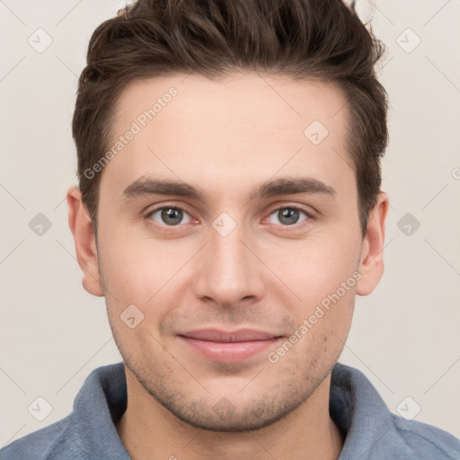 Joyful white young-adult male with short  brown hair and grey eyes