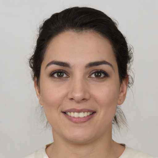 Joyful white young-adult female with medium  brown hair and brown eyes