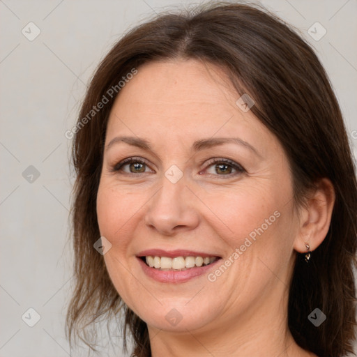 Joyful white adult female with medium  brown hair and grey eyes