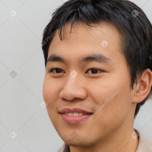 Joyful asian young-adult male with short  brown hair and brown eyes