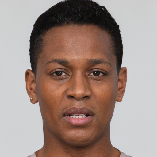 Joyful black young-adult male with short  black hair and brown eyes