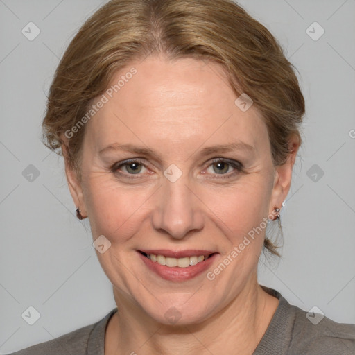 Joyful white adult female with medium  brown hair and grey eyes