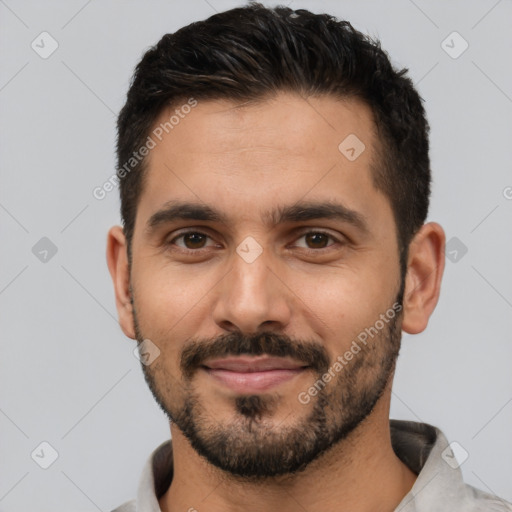 Joyful white young-adult male with short  black hair and brown eyes