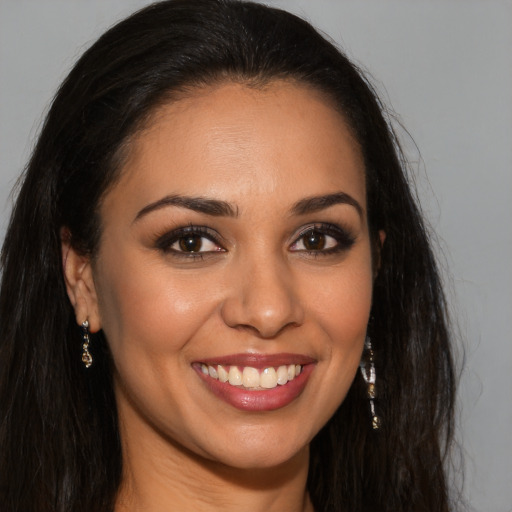 Joyful latino young-adult female with long  brown hair and brown eyes