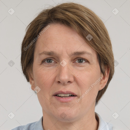 Joyful white adult female with short  brown hair and grey eyes