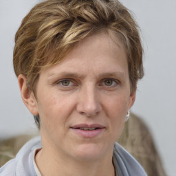 Joyful white adult male with short  brown hair and grey eyes