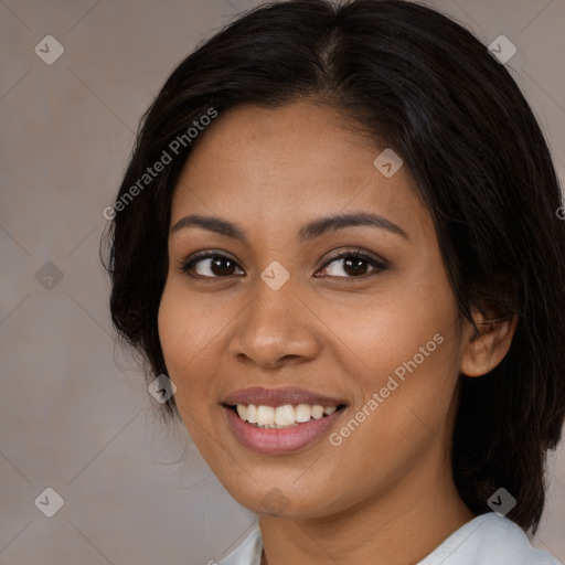 Joyful latino young-adult female with medium  brown hair and brown eyes