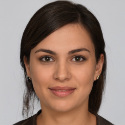 Joyful white young-adult female with medium  brown hair and brown eyes