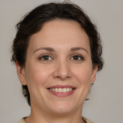 Joyful white adult female with medium  brown hair and brown eyes