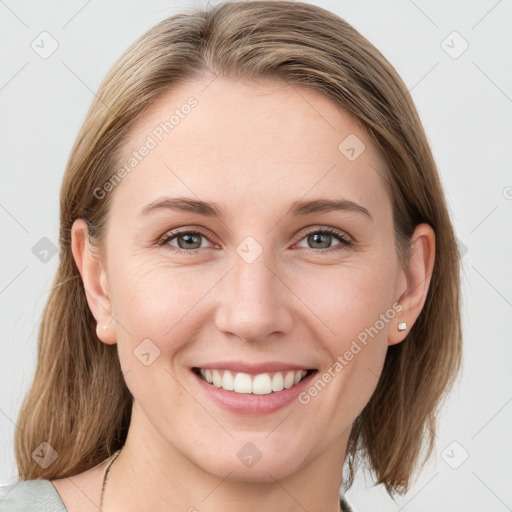 Joyful white young-adult female with medium  brown hair and blue eyes