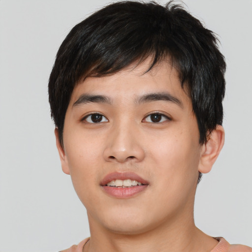 Joyful asian young-adult male with short  black hair and brown eyes